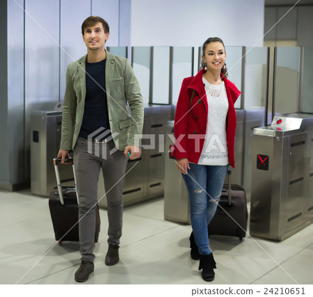 Young man and woman posing at baffle gate 24210651