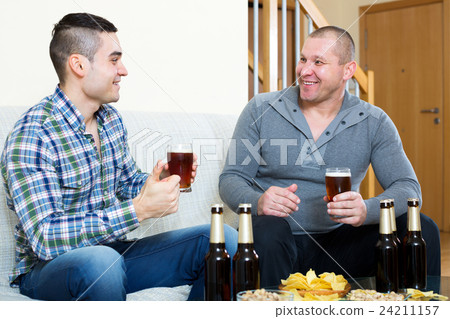 Two men drinking beer Two men drinking beer 24211157