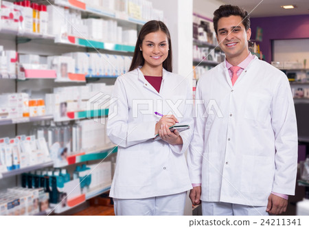 team of pharmaceutist and technician working in chemist shop 24211341