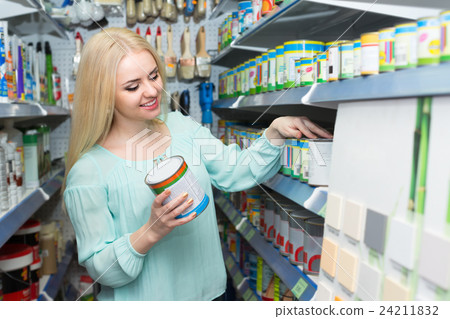 Woman choosing decorating paint . Woman choosing decorating paint . 24211832