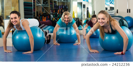 women jumping on exercise ball 24212236