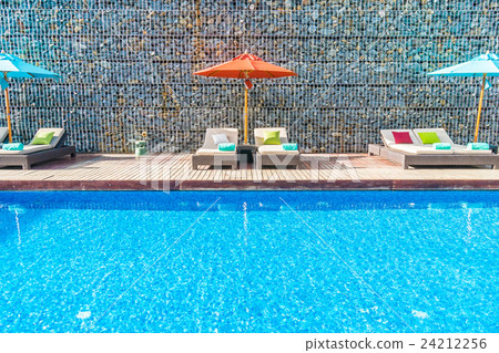 Umbrella and chair around swimming pool Umbrella and chair around swimming pool 24212256
