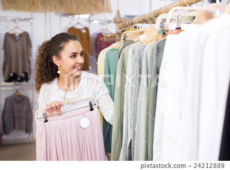 Woman buying new skirt at the store . 24212889