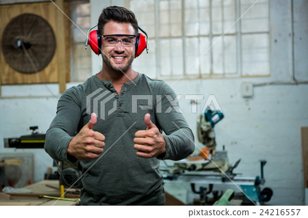 Carpenter is posing with his thumbs up and his protection equipment Carpenter is posing with his thumbs up and his protection equipment 24216557