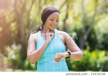 Happy woman posing and looking her watch 24218146