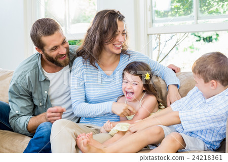 Parents and kids sitting on sofa and having fun Parents and kids sitting on sofa and having fun 24218361