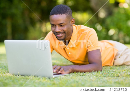 Happy man using his laptop 24218710