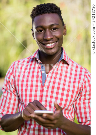 Happy man using his smartphone 24218750