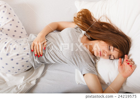 Sleepy woman sleeping in the bed. Sleepy woman sleeping in the bed. 24219575