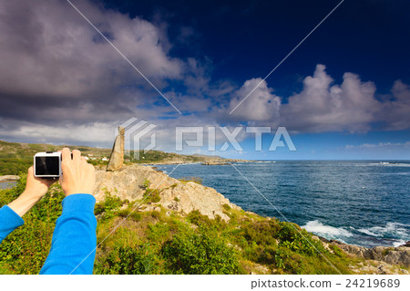 Woman tourist taking photo with camera in Norway Woman tourist taking photo with camera in Norway 24219689