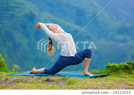 Sporty fit woman practices yoga asana Anjaneyasana Sporty fit woman practices yoga asana Anjaneyasana 24225033
