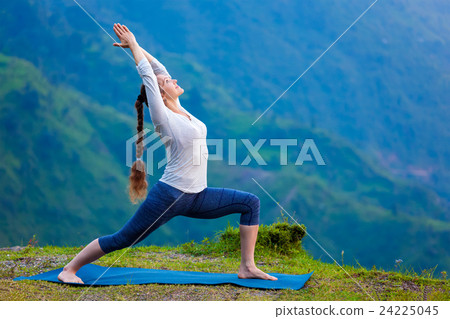 Woman doing yoga asana Virabhadrasana 1 - Warrior Woman doing yoga asana Virabhadrasana 1 - Warrior 24225045