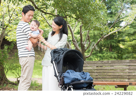 Babies and parents taking a walk in the park 24229082