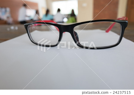 eye glasses placed on a blank paper sheet eye glasses placed on a blank paper sheet 24237515
