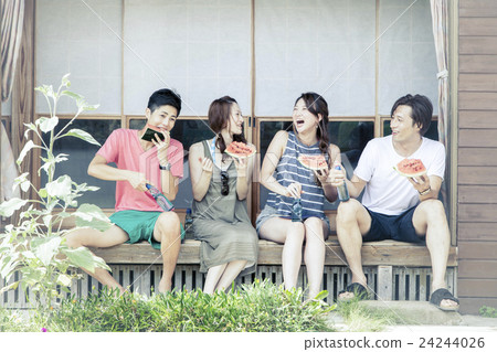 A man and a woman eating watermelon at the edge A man and a woman eating watermelon at the edge 24244026