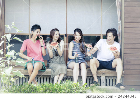 A man and a woman eating watermelon at the edge 24244343