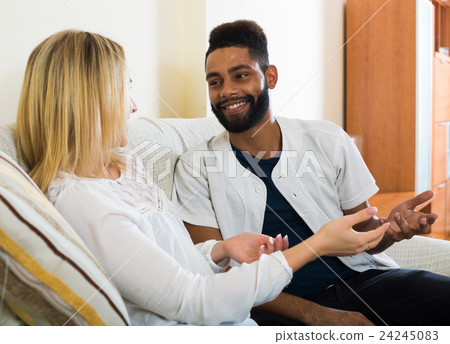 Happy young people sitting indoors and talking Happy young people sitting indoors and talking 24245083