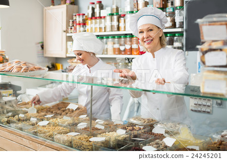 Friendly females staff offering nuts Friendly females staff offering nuts 24245201