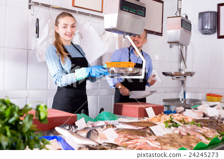 In shop offering fresh fish mature seller In shop offering fresh fish mature seller 24245273