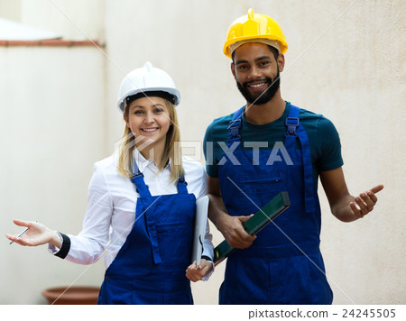 Smiling technicians smoothing the wall Smiling technicians smoothing the wall 24245505