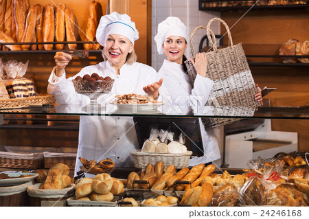 Cafe staff offering cakes 24246168