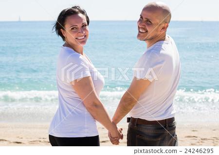 couple holding each other on the beach couple holding each other on the beach 24246295