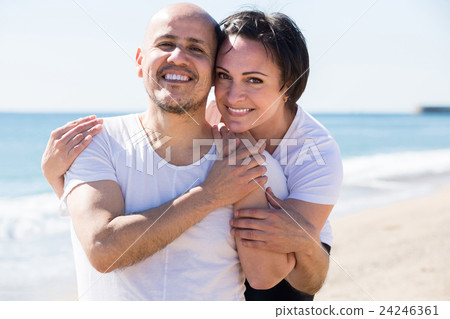 couple holding each other on the beach 24246361