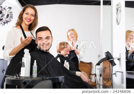 Hair stylist has done a haircut for man 24246606