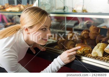 Happy girl with desserts in the cafe 24246609