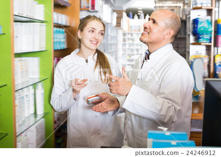 Professional pharmacist standing at pay desk 24246912