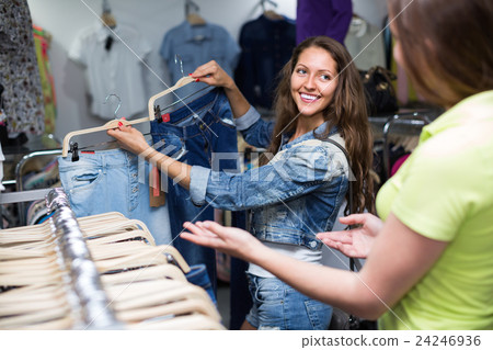 Woman shopper choosing jeans at shop. 24246936