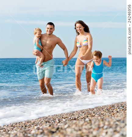 Family with two kids on beach Family with two kids on beach 24246956