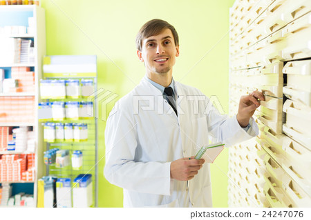 pharmacist working in pharmacy pharmacist working in pharmacy 24247076