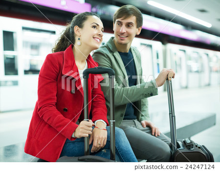 Couple waiting for train 24247124