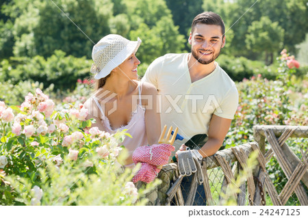 Young couple gardening together . Young couple gardening together . 24247125