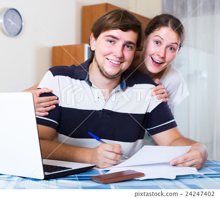 family couple sitting at desk with documents indoors 24247402