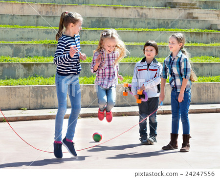 Children playing skipping rope jumping game Children playing skipping rope jumping game 24247556