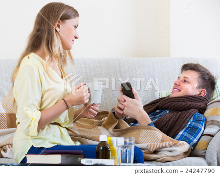 Wife taking care of husband with flue. 24247790