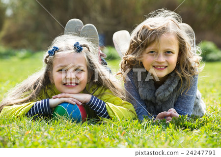 girls relaxing in grass girls relaxing in grass 24247791