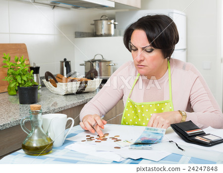 Miserable female counting money for payment 24247848