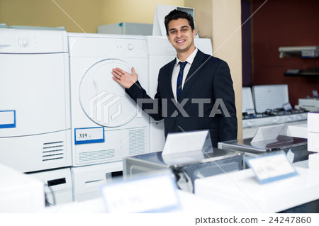 Friendly male seller at household appliances section Friendly male seller at household appliances section 24247860