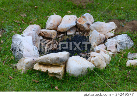 Open fire outdoors.Chic bonfire topped with stones Open fire outdoors.Chic bonfire topped with stones 24249577