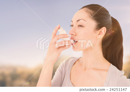 Composite image of asthmatic pretty brunette using inhaler Composite image of asthmatic pretty brunette using inhaler 24251147