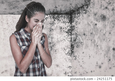 Composite image of sick blonde woman sneezing in a tissue Composite image of sick blonde woman sneezing in a tissue 24251175