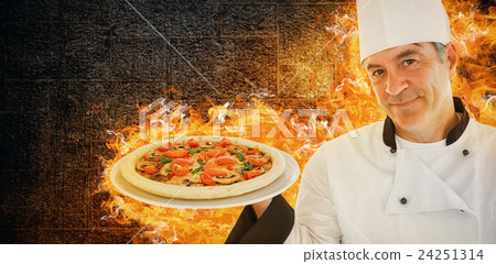 Composite image of friendly chef holding a pizza 24251314