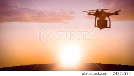 Composite image of a drone bringing a red cube 24251554