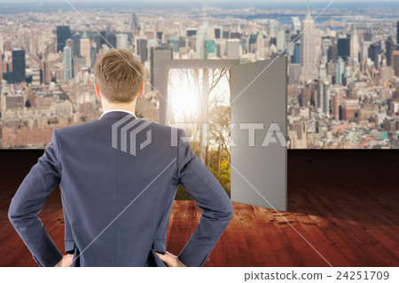 Composite image of rear view of businessman standing with hands on wiast Composite image of rear view of businessman standing with hands on wiast 24251709