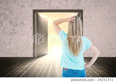 Composite image of rear view of a blonde posing with hand on hip 24251711