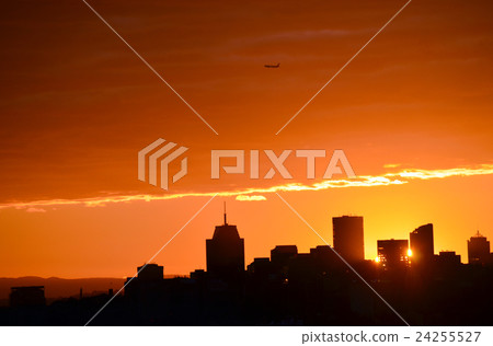 Sunset behind city skyline 24255527