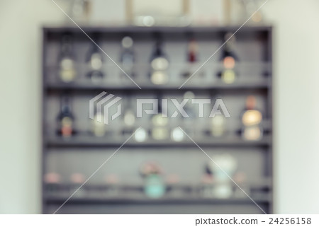Blurred bar back with shelves of liquor bottles 24256158